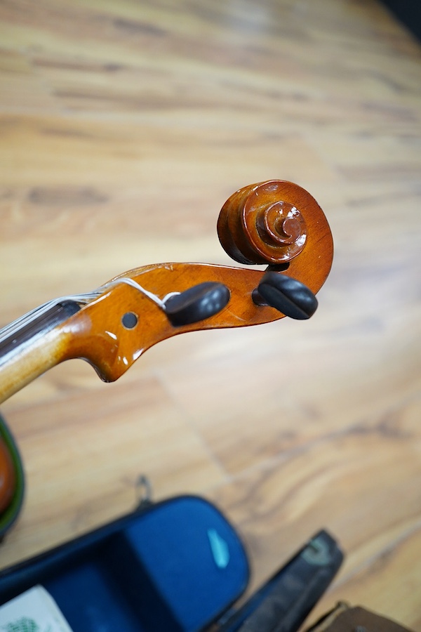 A quantity of violin parts and violins, a ukelele, a double bass scroll, a pinfold metronome, a violin case by Hill, a viola etc. Condition - for restoration